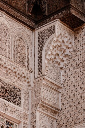 Detailed view of intricate Moorish architectural decoration at Alhambra in Granada, Spain.
