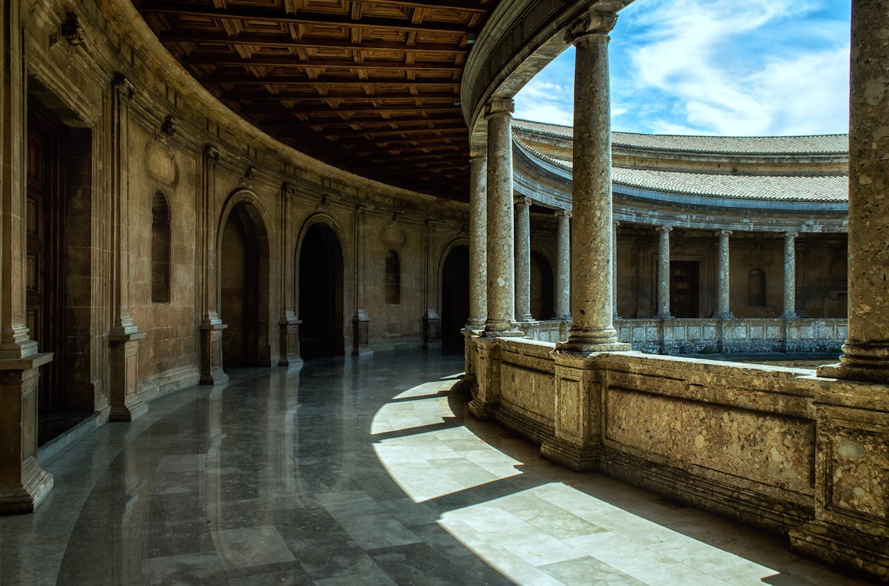 Stunning architectural view of Alhambra's courtyard in Spain, showcasing historical design and stone columns.