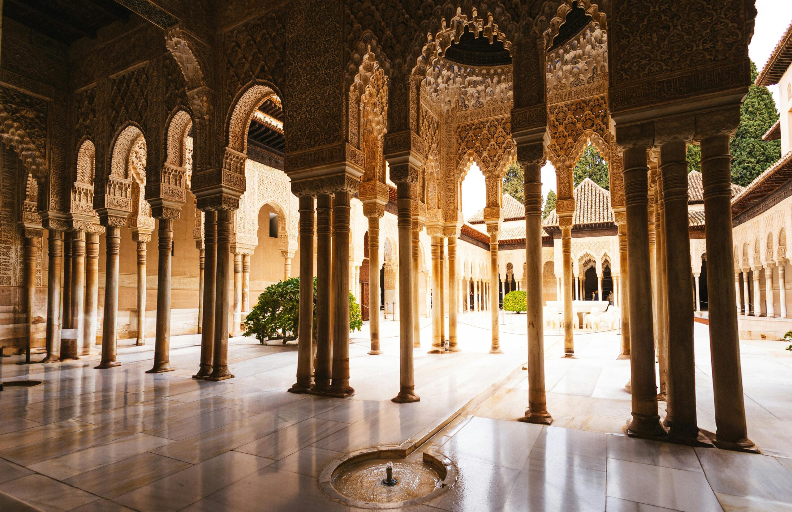 Experience the intricate arches and columns of Alhambra's stunning courtyard in Granada.